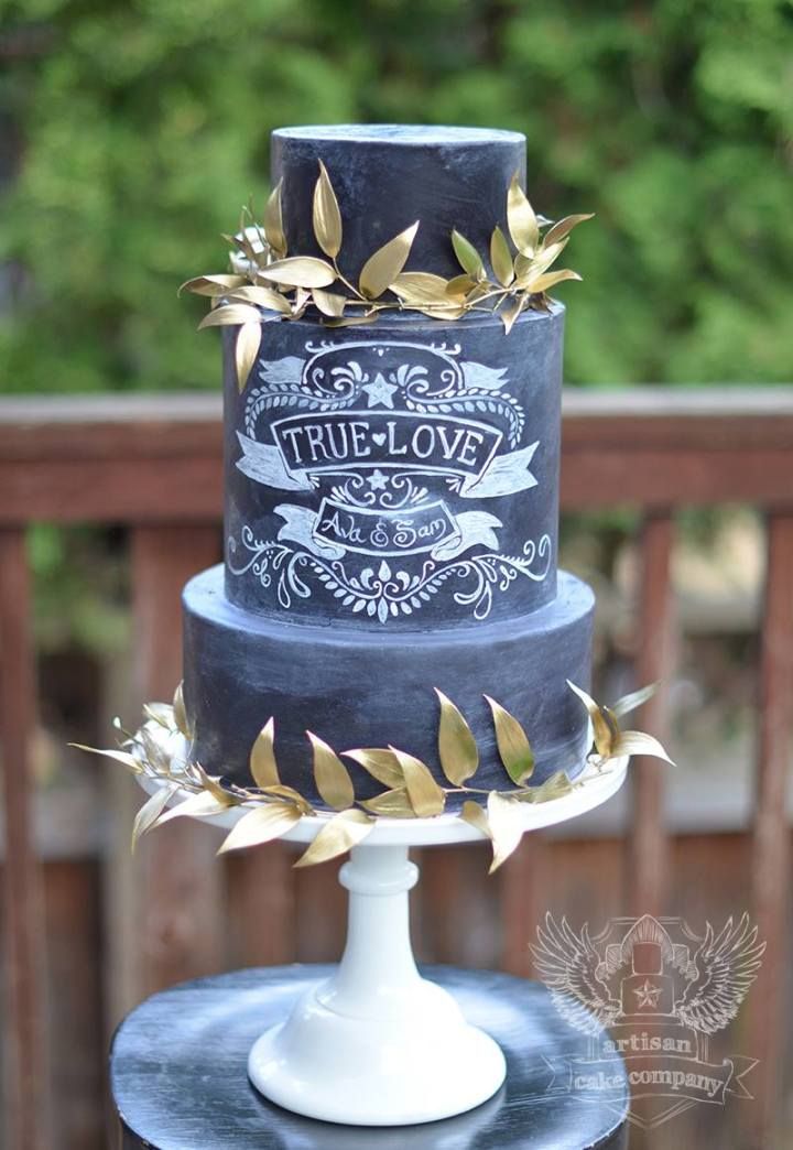 Black chalkboard wedding cake with gold leaves