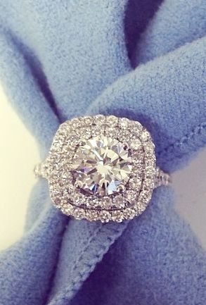 Cushion shaped double halo engagement ring featuring a round brilliant cut diamond with a double shank