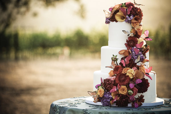 Dress up a classic white fall wedding cake with a cascading flowers and butterflies