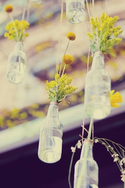 Hanging vintage bottles with simple floral arrangements