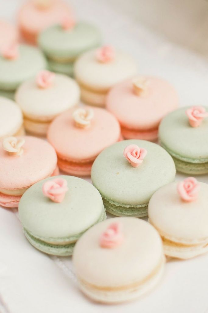 Mint peach and cream french macarons with roses as dessert