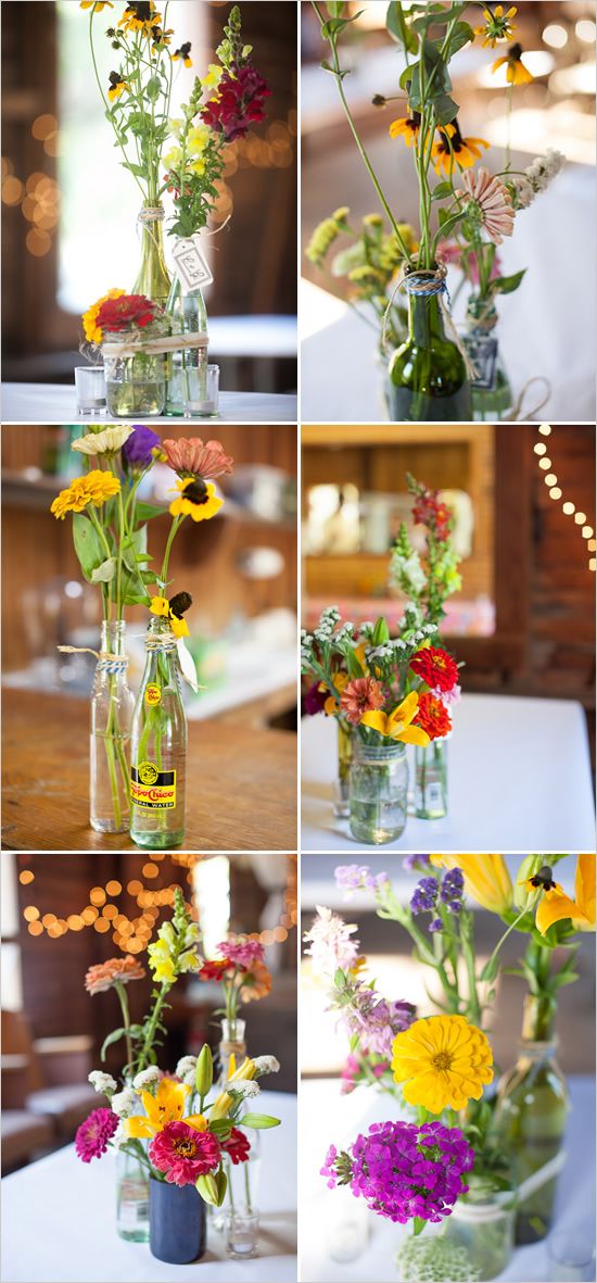 Mixed bottle centerpieces with an assortment of wild flowers