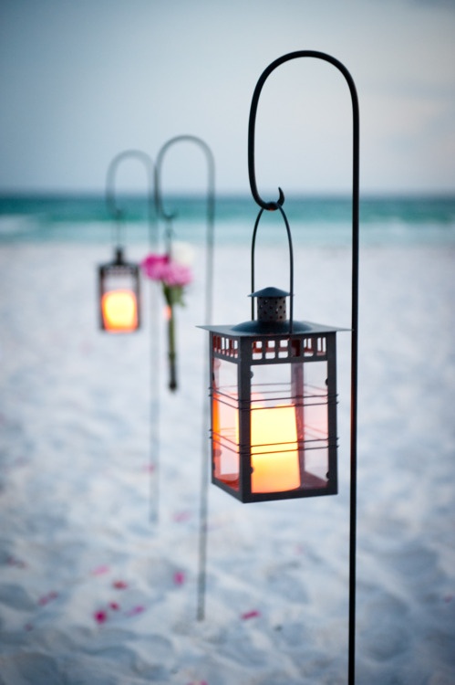 Nautical lanterns with flickering candles at sunset