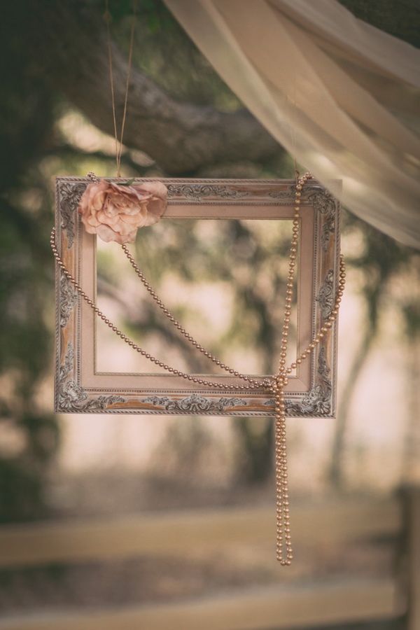 Old vintage picture frame with flower and pearls decor for a vintage wedding