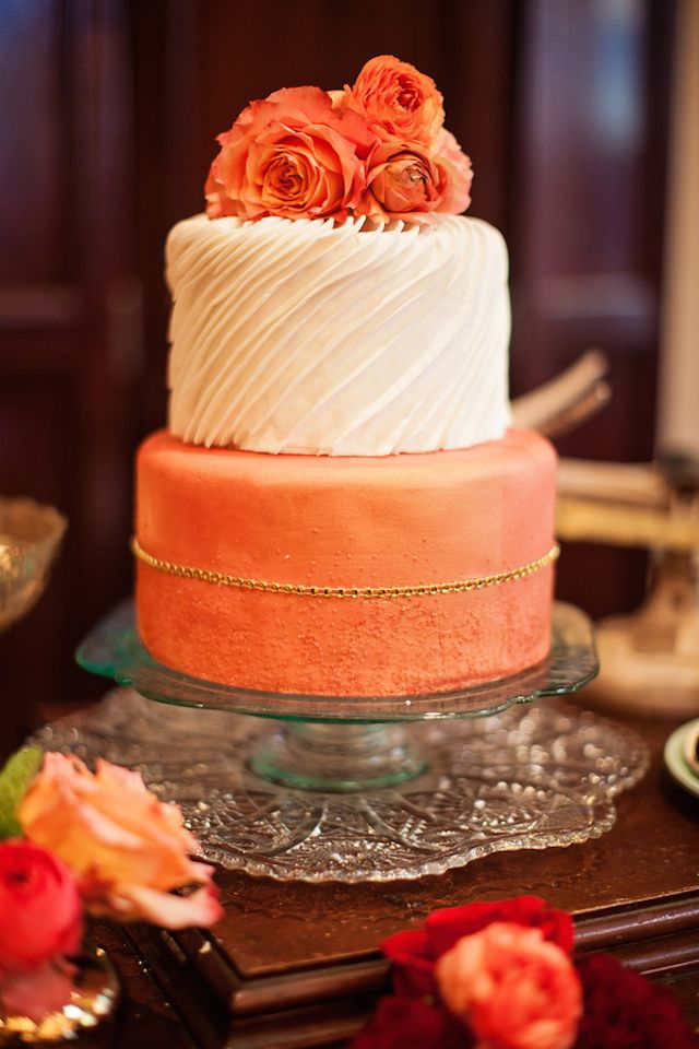 Peach fall wedding cake topped with ranunculus