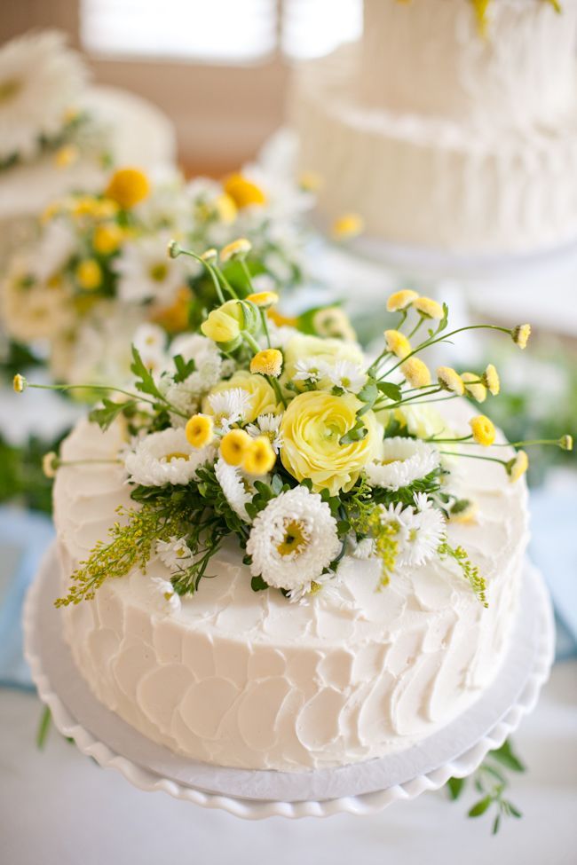 Poms on a simple white buttercream wedding cake