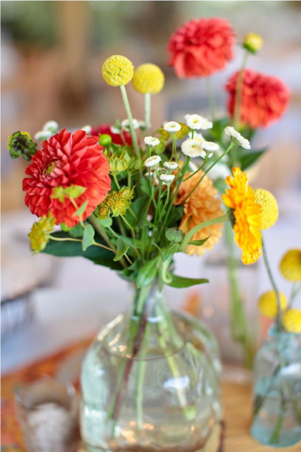 Red, orange and yellow flowers in mason jar