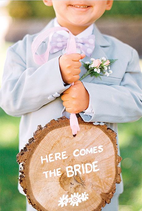 Ring Bearer and signs on tree stump