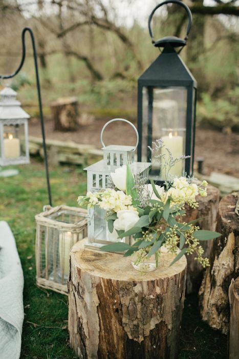 Simple floral and lantern tree stump wedding decor