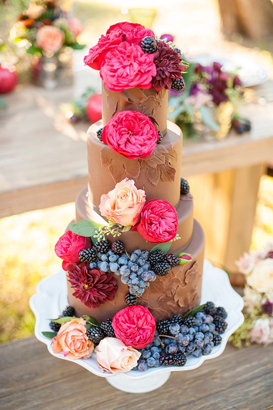 Tiered Chocolate wedding cake with flowers and fruit