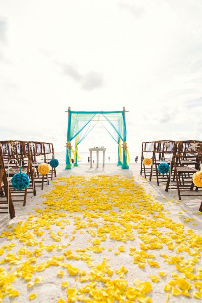 Yellow and Turquoise Beach Wedding Ceremony Decor with Yellow Rose Petals and Teal Bamboo Arch