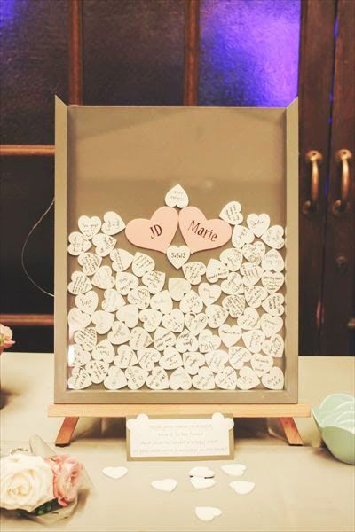 ave each guest sign a small wooden heart and drop it in a shadow box frame