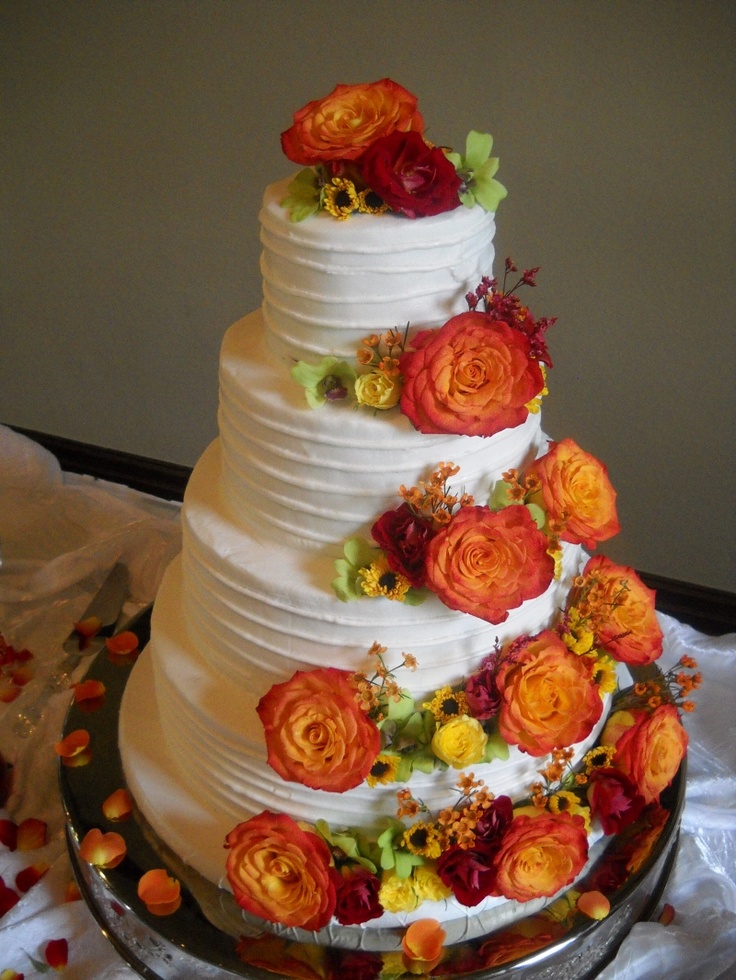 awesome buttercream fall wedding cake with orange roses