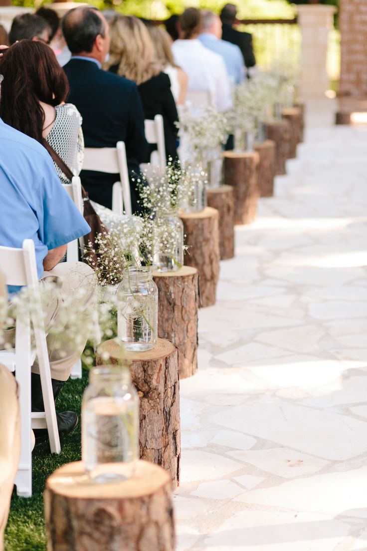 baby's breath in jar tree stump rustic wedding aisle