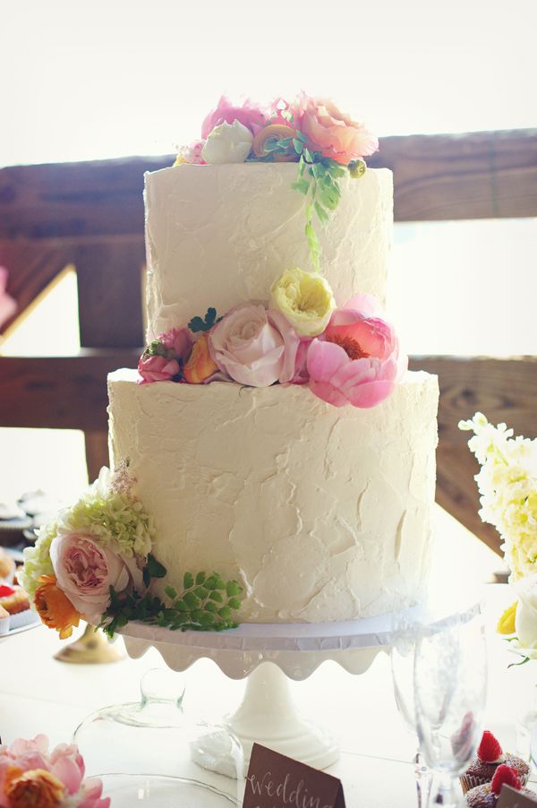 buttercream wedding cake with pastel flowersjpg