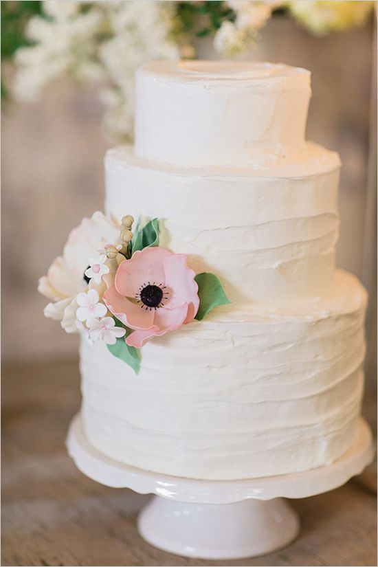 buttercream wedding cake with pink anemone