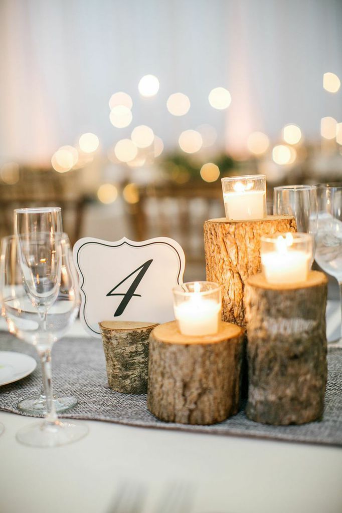 50+ Tree Stumps Wedding Ideas for Rustic Country Weddings 17 candles on tree stumps centerpiece for wedding
