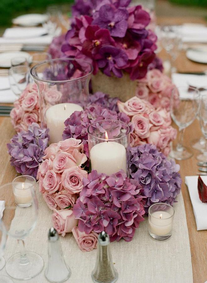 candles surrounded by vase-free flowers