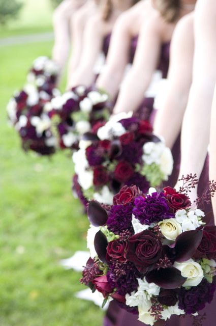 combo of roses carnations and calla lilies for a plum wedding