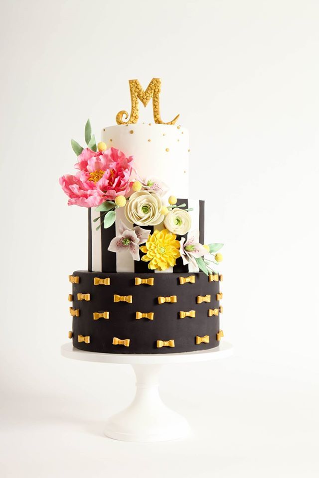 cute gold black and white wedding cake with pastel flowers