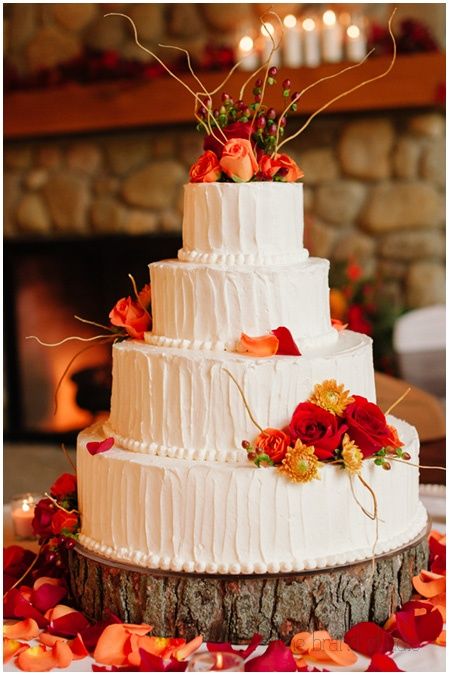 fall wedding cake ideas-white buttercream and red orange flowers