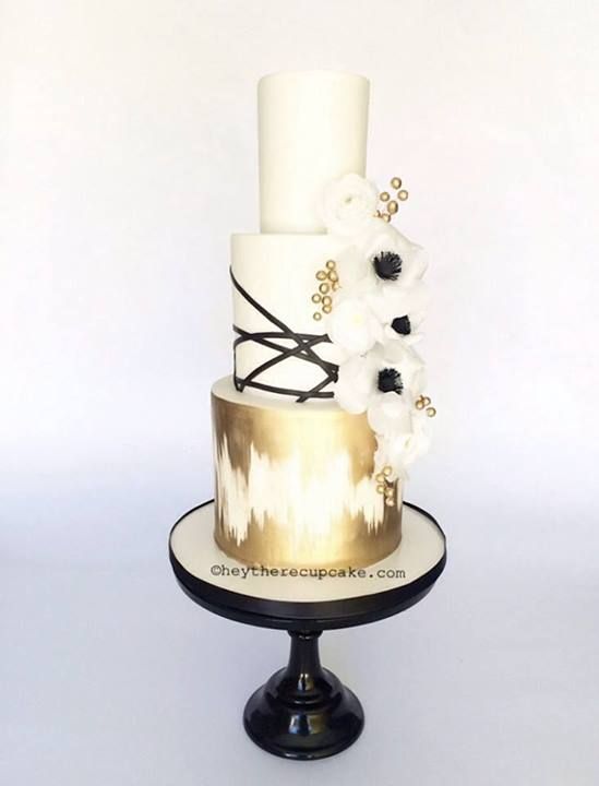 gold and white wedding cake with anemone