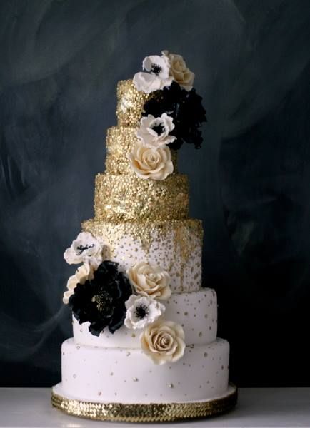 gold wedding cake with black floral accents