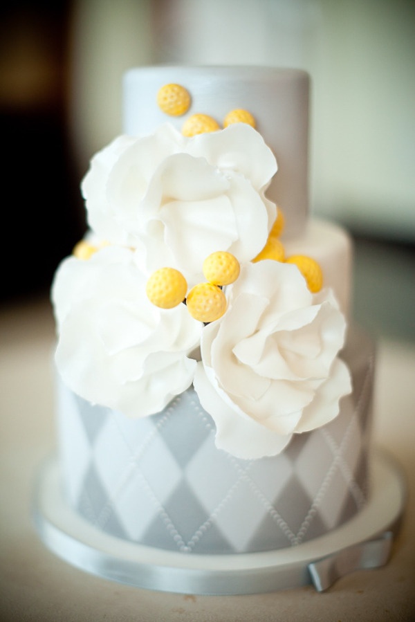 grey and white wedding cake with sugar yellow billy balls