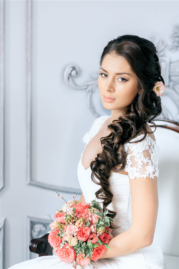 half up hairstyle for wedding with pink flower