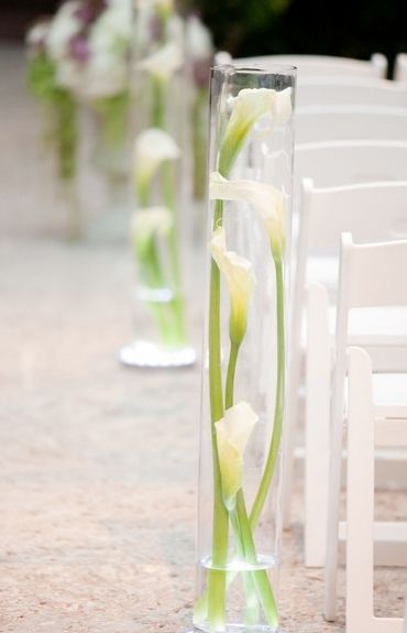 lily in bottle beach wedding aisle