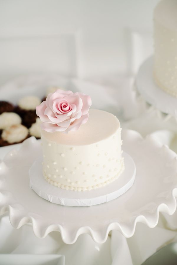 mini white wedding cake and pink sugar flower