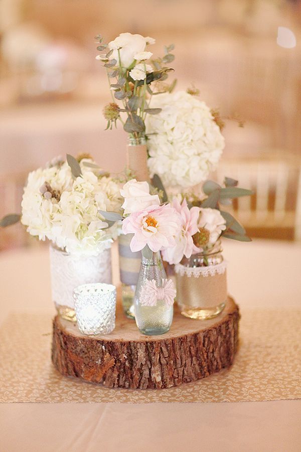 mismatched vases on wood stump