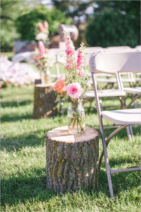 rustic stump and floral as wedding ceremony aisle decor