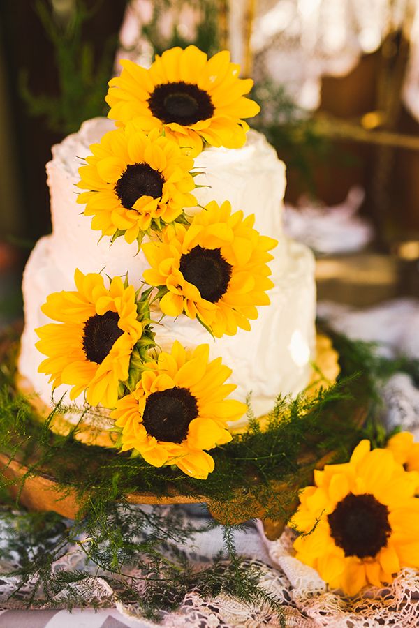 simple cream wedding cake with yellow sunflowers
