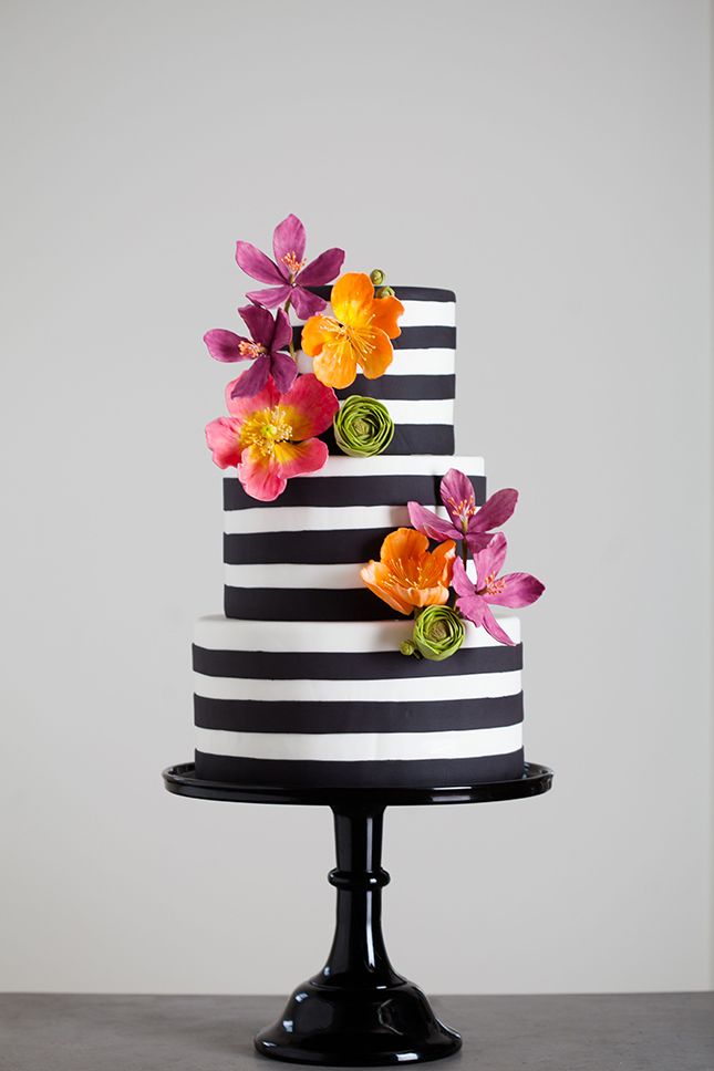 striped black and white wedding cake with flowers