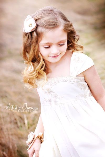 sweet curly flower girl hairstyle with flower