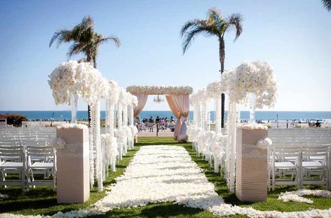 tall flowers beach wedding aisle