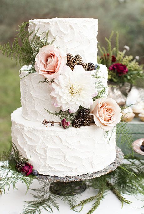 three-tiered white wedding cake with textured buttercream and fresh flowers and berries by Elise Cakes