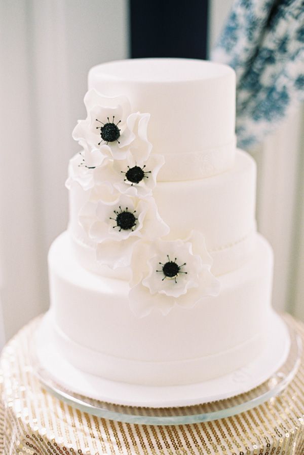 white and black wedding cake with white poppy flowers