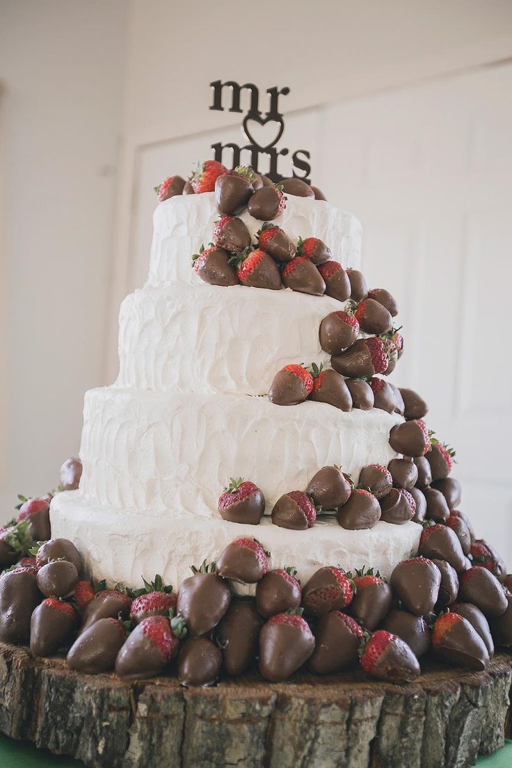 white wedding cake with chocolate covered strawberries