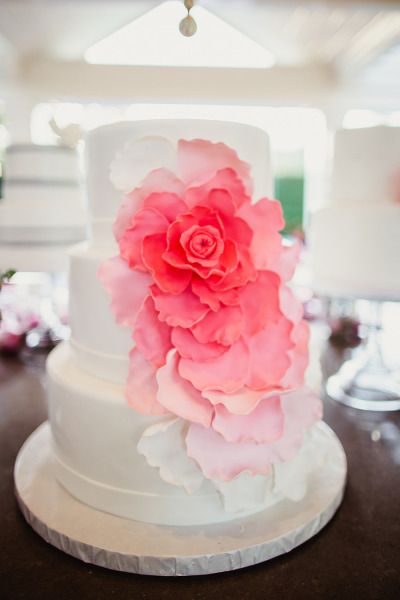 white wedding cake with pink ombre sugar flower