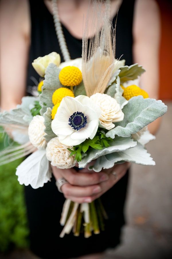 winter wedding bouquet with anemone billy buttons and feathers