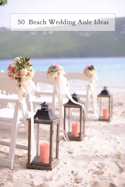 wooden lanterns with coral pillar candles lining the aisle