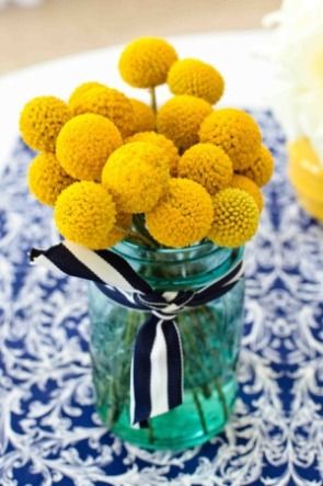 yellow billy balls in blue mason jar wedding centerpieces