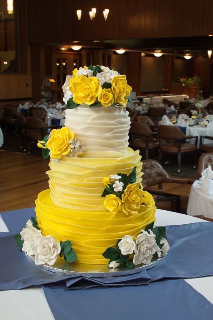 yellow ombre wedding cake with white and yellow sugar flowers