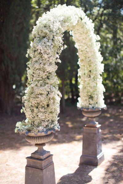 25+ Stuning Wedding Arches with Lots of Flowers 15 Baby's breath flower wedding arch