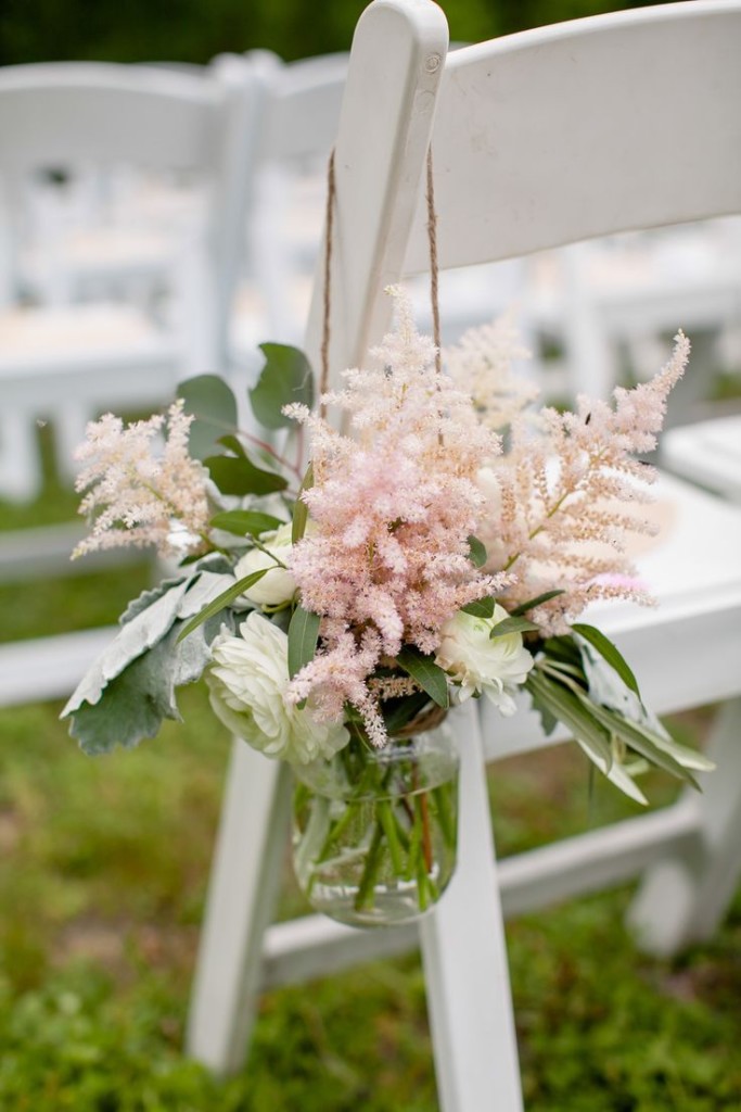 Blush pink astilbe decorates the aisle