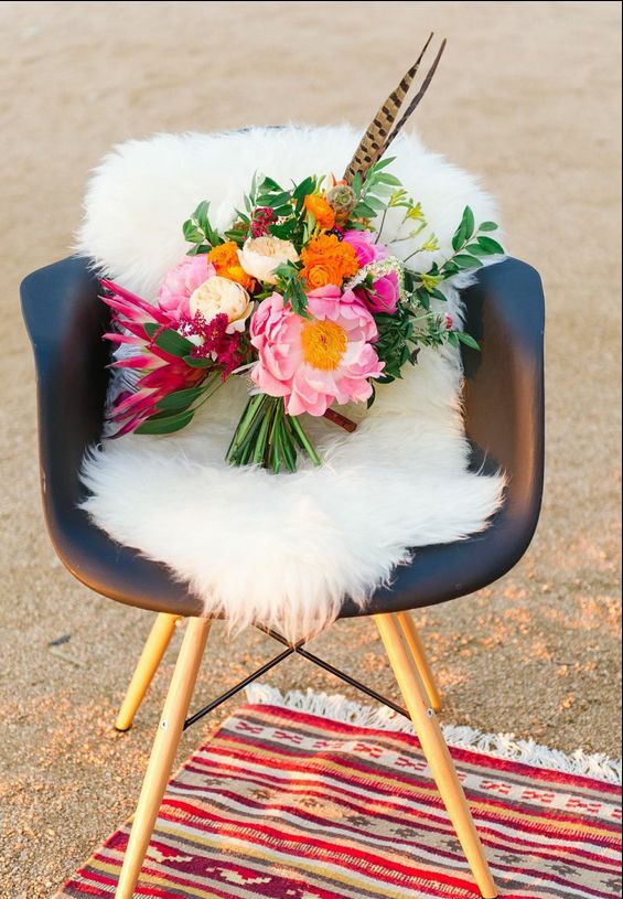 Bright and colorful wedding wedding bouquet with feathers