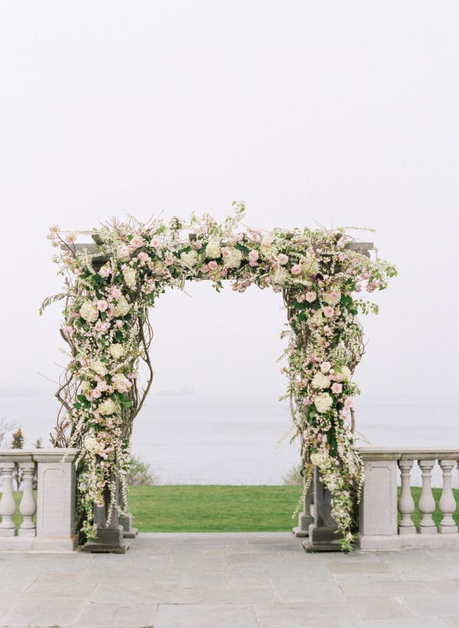 Floral covered rustic wedding arch