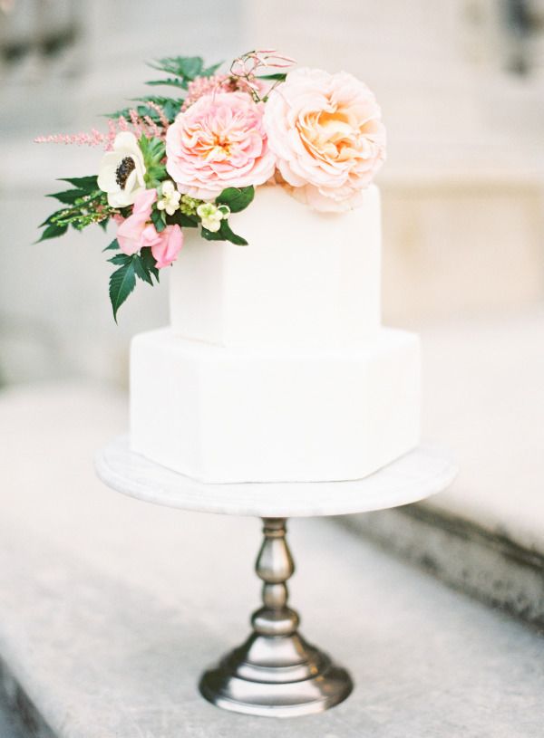 Geometric white wedding cake with pastel flowers